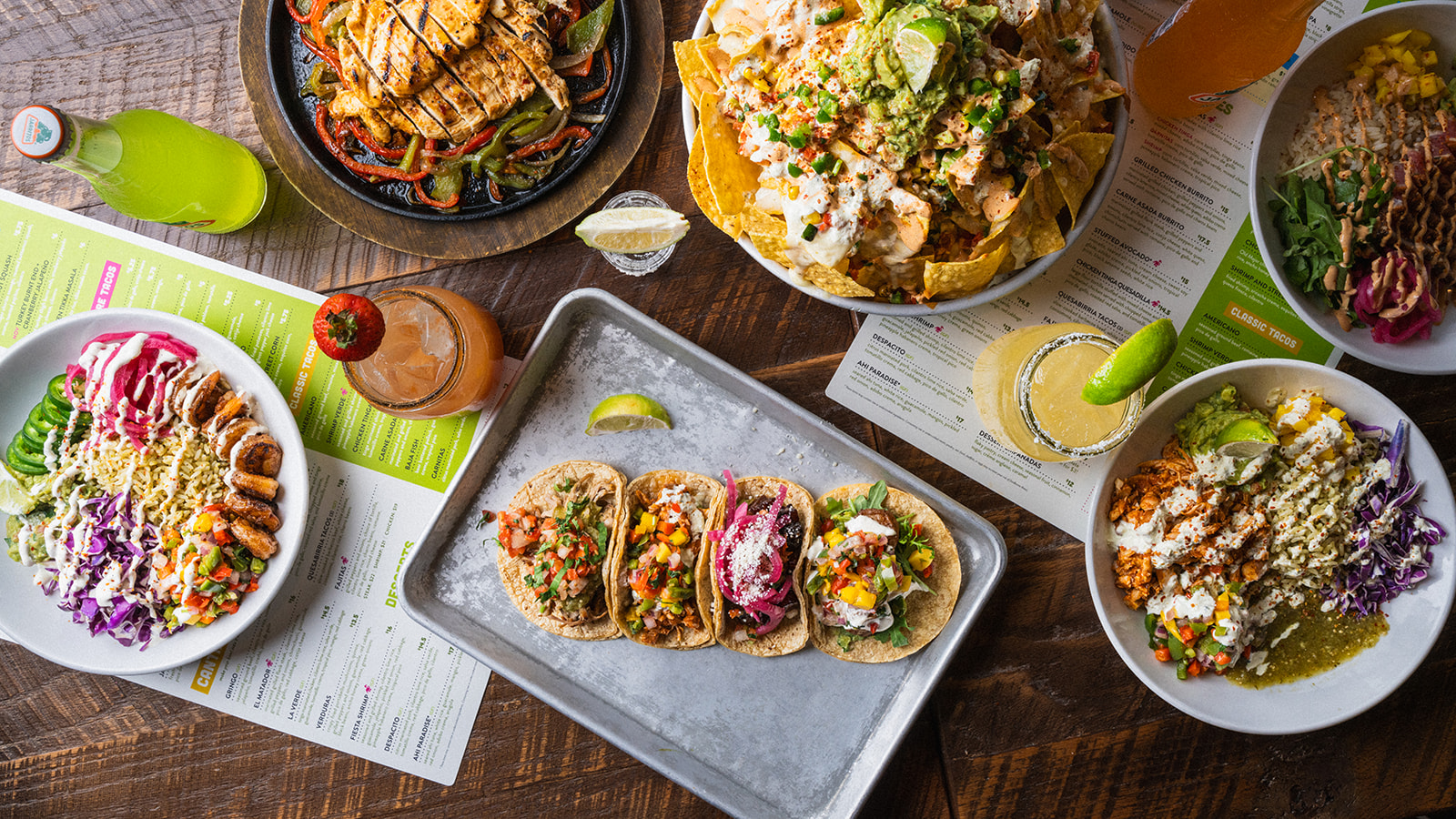 Tacos, cantina bowls and margaritas laid out on a table at Social Cantina Nashville