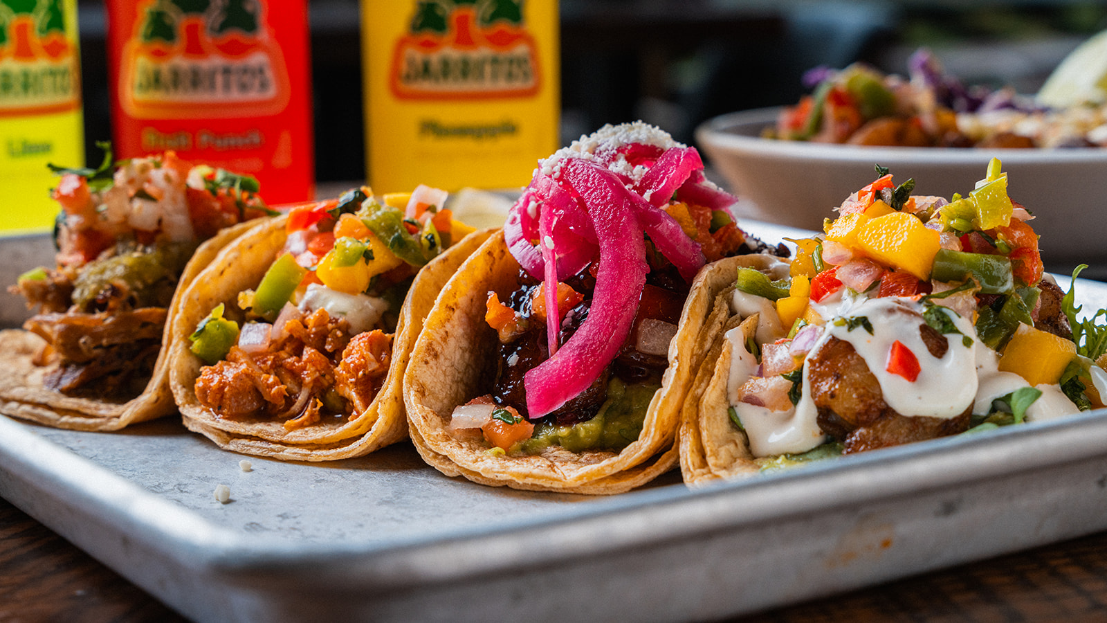 A tray of four street tacos with pickled onion, mango and crema at Social Cantina in Germantown, Nashville