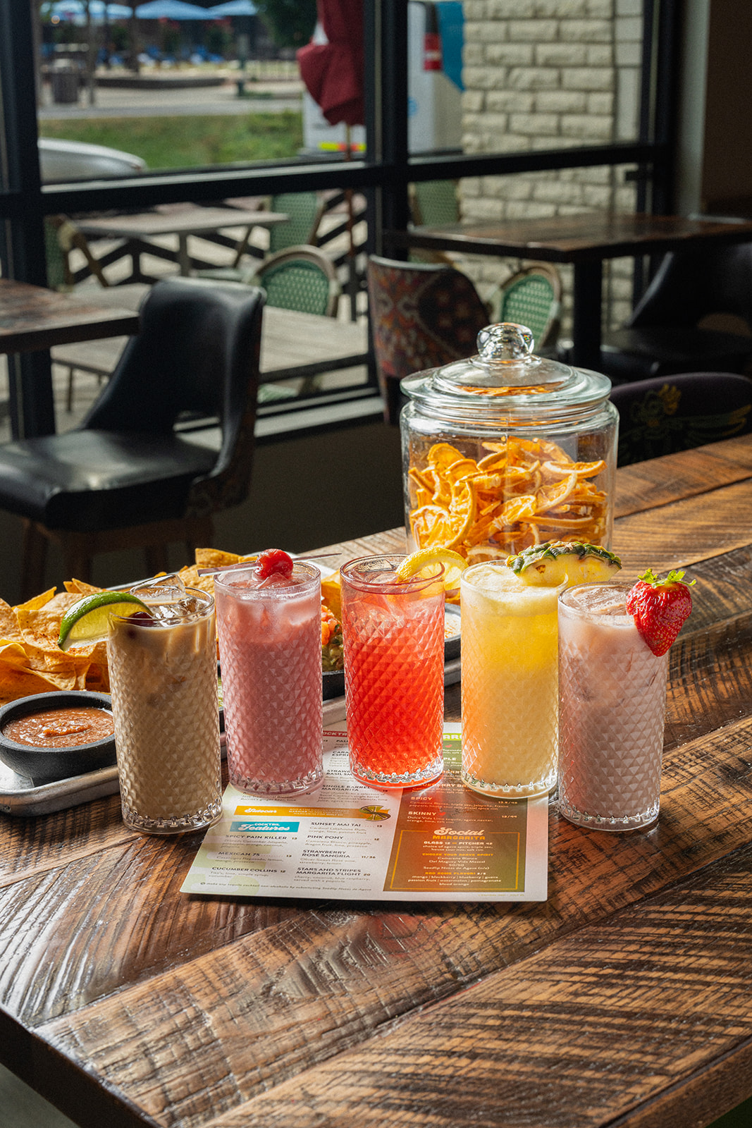 A flight of cocktails on a table by the window at Social Cantina in downtown Nashville